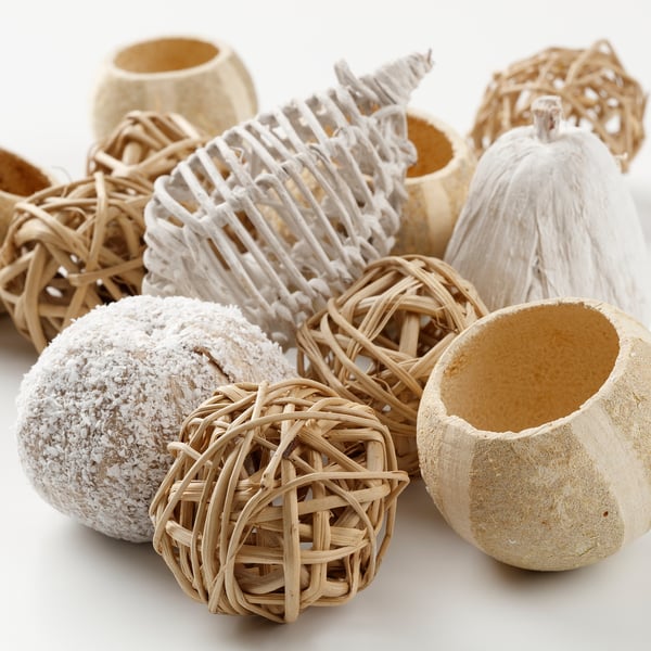 Handcrafted potpourri pieces in various shapes, some with white texture. Arranged together, showcasing natural, rustic beauty and unique appearances.