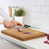 Slicing onion with knife from set.