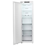 An open white upright freezer with multiple shelves by fornas.