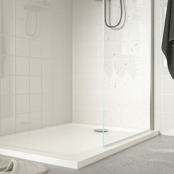 Modern anti-slip shower tray in minimalist tiled enclosure, low profile for easy access and water saving.