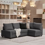 Modern living room with l-shaped gray sofa, cushions, and storage shelves.