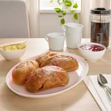 Pastries, butter, jam, coffee on table