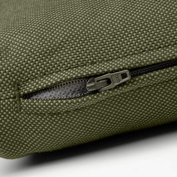 Green outdoor furniture zipper, durable and made from recycled materials.
