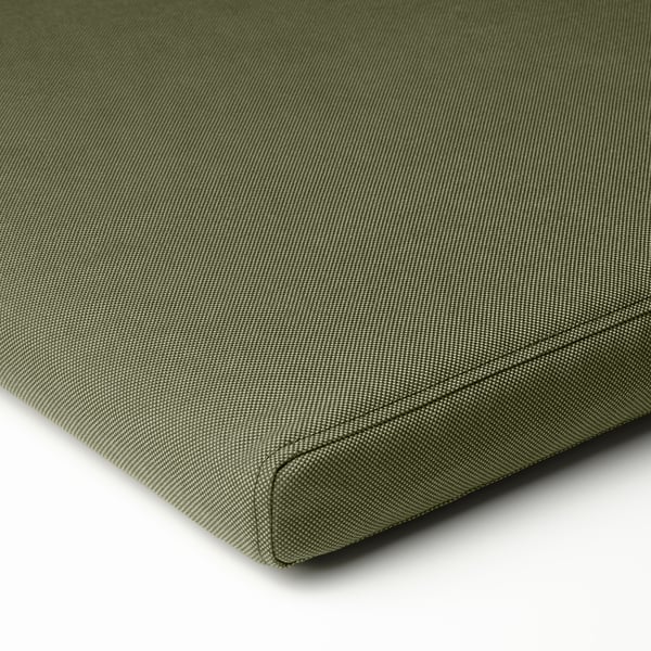 Green outdoor cushion close-up; smooth fabric, even stitching, quality design.