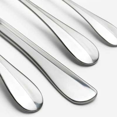 GAMMAN stainless steel cutlery set. Fork, knife, large spoon, and small spoon with sleek, modern design.