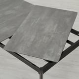 Extendable dining table with sleek design in photo. Gray embossed stone-like top, durable, and easy to clean. Aluminium legs provide sturdy support.