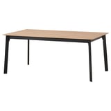 A GILLANDA extendable dining table with a light brown top and black metal legs. Modern and sleek design.