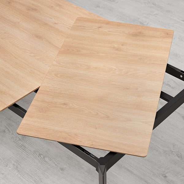 Extending dining table with aluminum legs. Hides extra leaf underneath for easy access.