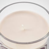Glass container candle with beige wax, single wick, clean, unlit, high quality, smooth surface.