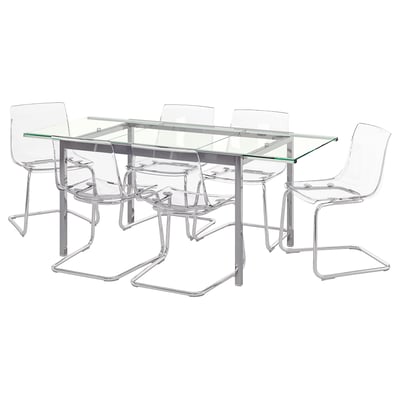 Modern glass-top dining table with four clear plastic chairs, chrome legs, sleek, minimalist design.