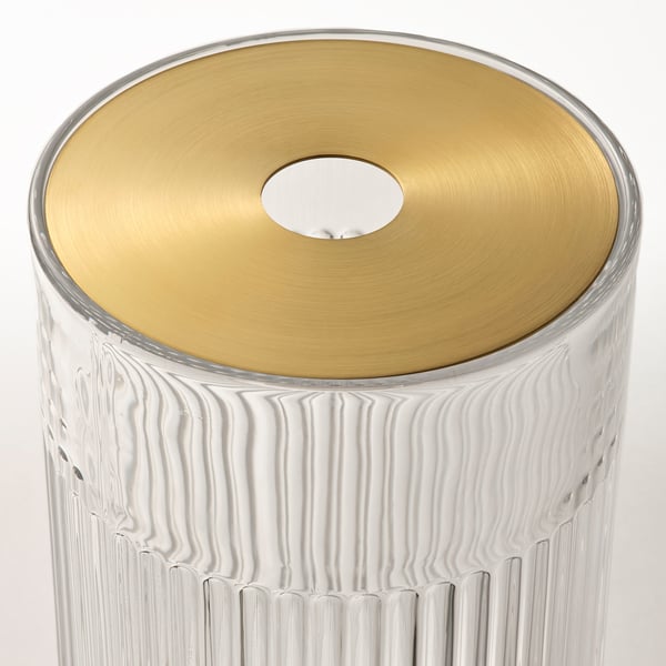 Clear glass vase with vertical grooves, golden metal lid, single flower stem holder.