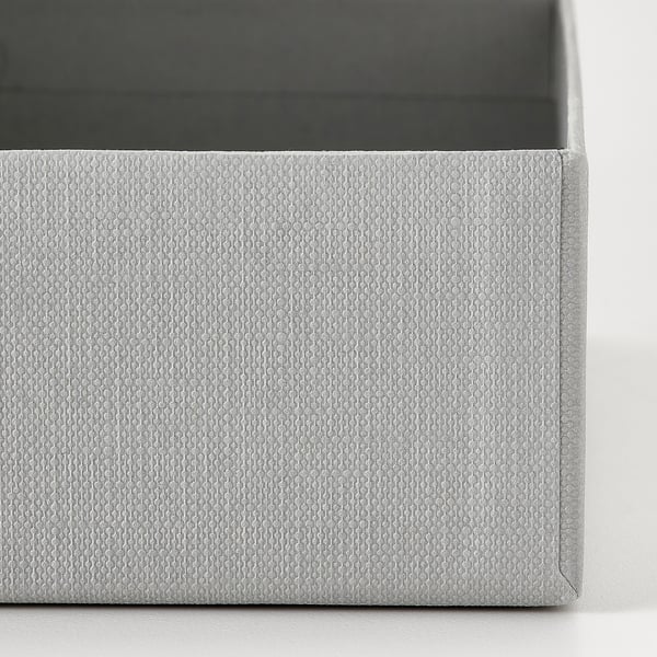 Close-up of gray textured cardboard box, neatly folded with intricate pattern, part of organizing set.
