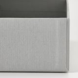 Close-up of gray textured cardboard box, neatly folded with intricate pattern, part of organizing set.