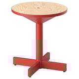 A grimsoabo side table, red with a round wooden top, three splayed metal legs, and a modern scandinavian design.