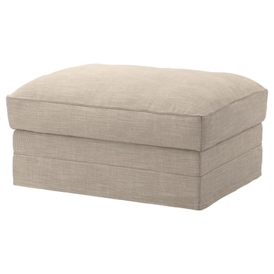 Depicts a beige-colored, rectangular-shaped footstool with a padded, textured fabric cover. It has a simple, modern design with smooth, rounded edges.