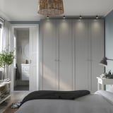 Modern GULLABERG bedroom, gray ceiling-high doors with led lights. Bathroom with white & dark mat visible.