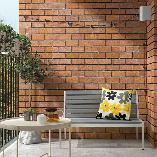 Gray cushion on bench with tea set and plant.