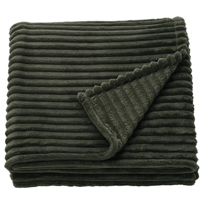Dark green folded blanket with textured stripes and scalloped edge.