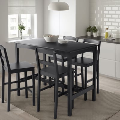 Black dining set with table and 4 chairs, modern & compact, pine material.