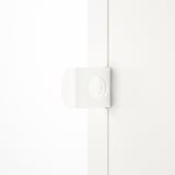 White modern storage cabinet with rounded edges and a lock, mounted on a wall. Sleek, minimalist design.