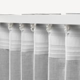 Close-up of white curtains with clips. They block glare and provide privacy while allowing diffused light.