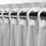 Blackout curtains with rod pocket heading, providing privacy and light control.