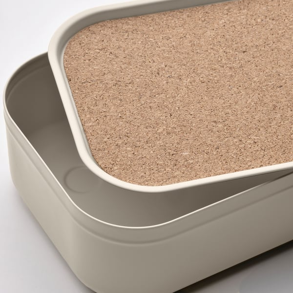 Stack of two HARVMATTA storage boxes. Top box has cork lid, bottom box is metallic.