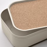 Stack of two HARVMATTA storage boxes. Top box has cork lid, bottom box is metallic.
