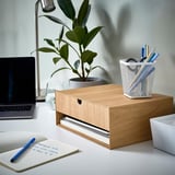 Oak mini chest with drawers and shelves on desk with laptop and pens.