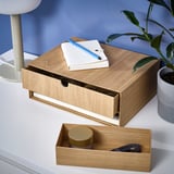 Wooden mini chest with open shelf and drawer for desk organization, holding books and accessories.