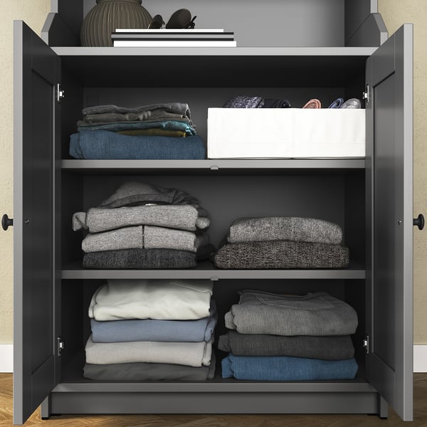 HAUGA storage unit, grey, wood & fiberboard, 3 shelves, folded clothes, accessories on top.