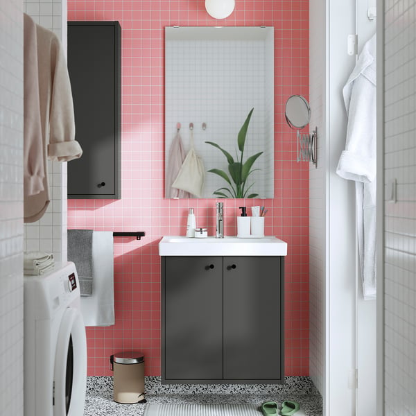 Modern bathroom with pink tiles, grey HAVBÄCK vanity, white sink, and mirror.