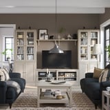 Gray living room with sofas, rug, tv unit, decor, lamp, window, cozy vibe.