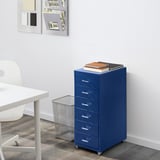 Blue mobile filing cabinet under desk, holding books on top, organized workspace.