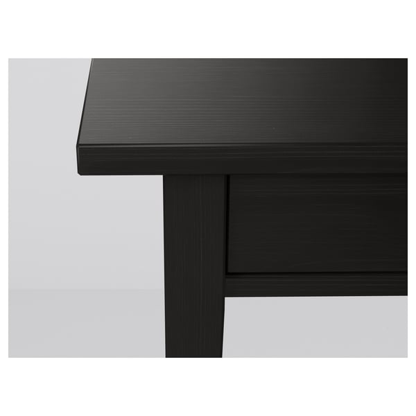 Black wooden table corner, smooth finish, sturdy design.