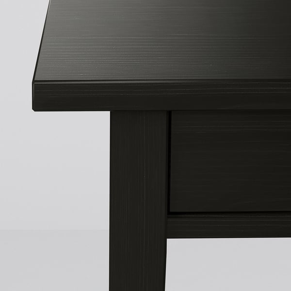 Dark wooden table corner, smooth finish, sturdy construction.