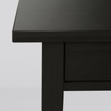 Dark wooden table corner, smooth finish, sturdy construction.