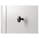 Black metal hook on white wall, simple & sturdy design.