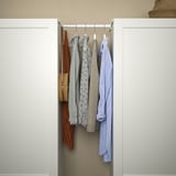 Open closet showing various hanging shirts, optimized space use.