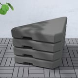 Stacked grey heavy duty parasol bases on wooden deck.