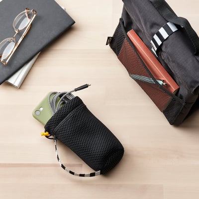 Mesh bottle carrier with phone & charging cable; backpack with water bottle.