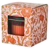 The HÖSTAGILLE scented candle in an orange floral box. It has a clear glass jar with a black lid. The candle is orange and made of plant-based wax.