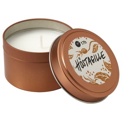 Small round copper scented candle tin with lid, white wax, nature-inspired design, HÖSTAGILLE label.