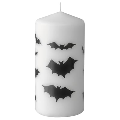White halloween themed candle with black bat silhouettes, cylindrical shape, cotton wick.