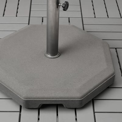 Heavy concrete parasol base with metallic pole and handles, designed for outdoor stability and ease of movement.