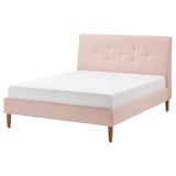 IDANÄS bed: pink, soft, tufted headboard, wooden legs, minimalist design.