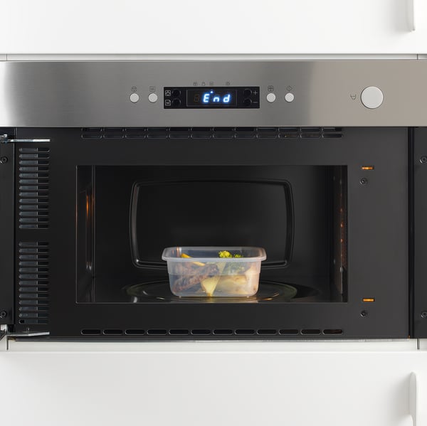 A microwave oven with food container inside. Digital display shows end.