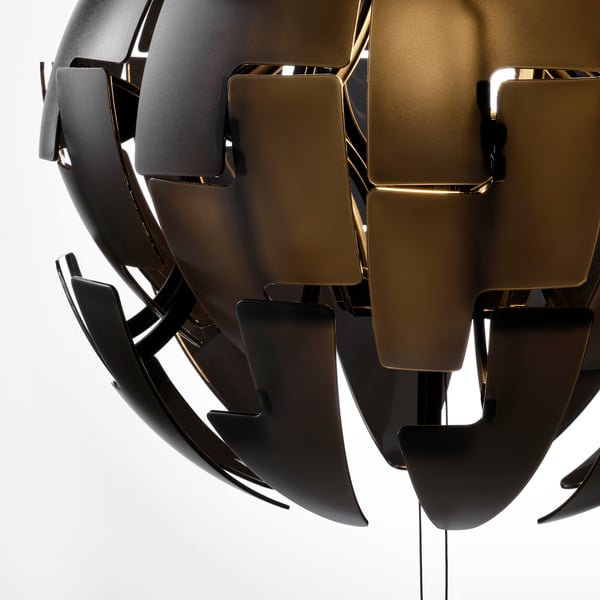 Modern pendant lamp with black, transparent plastic panels in geometric shapes, emitting warm light.
