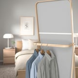 Wooden clothing rack with mirror; reflects and holds clothes behind for easy morning access.
