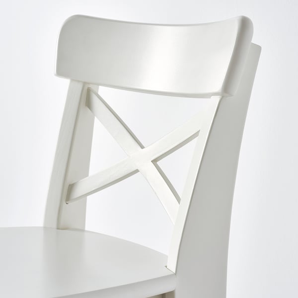 White junior chair with curved back, cross-patterned backrest, and flat seat. Designed for childrens comfort and support.